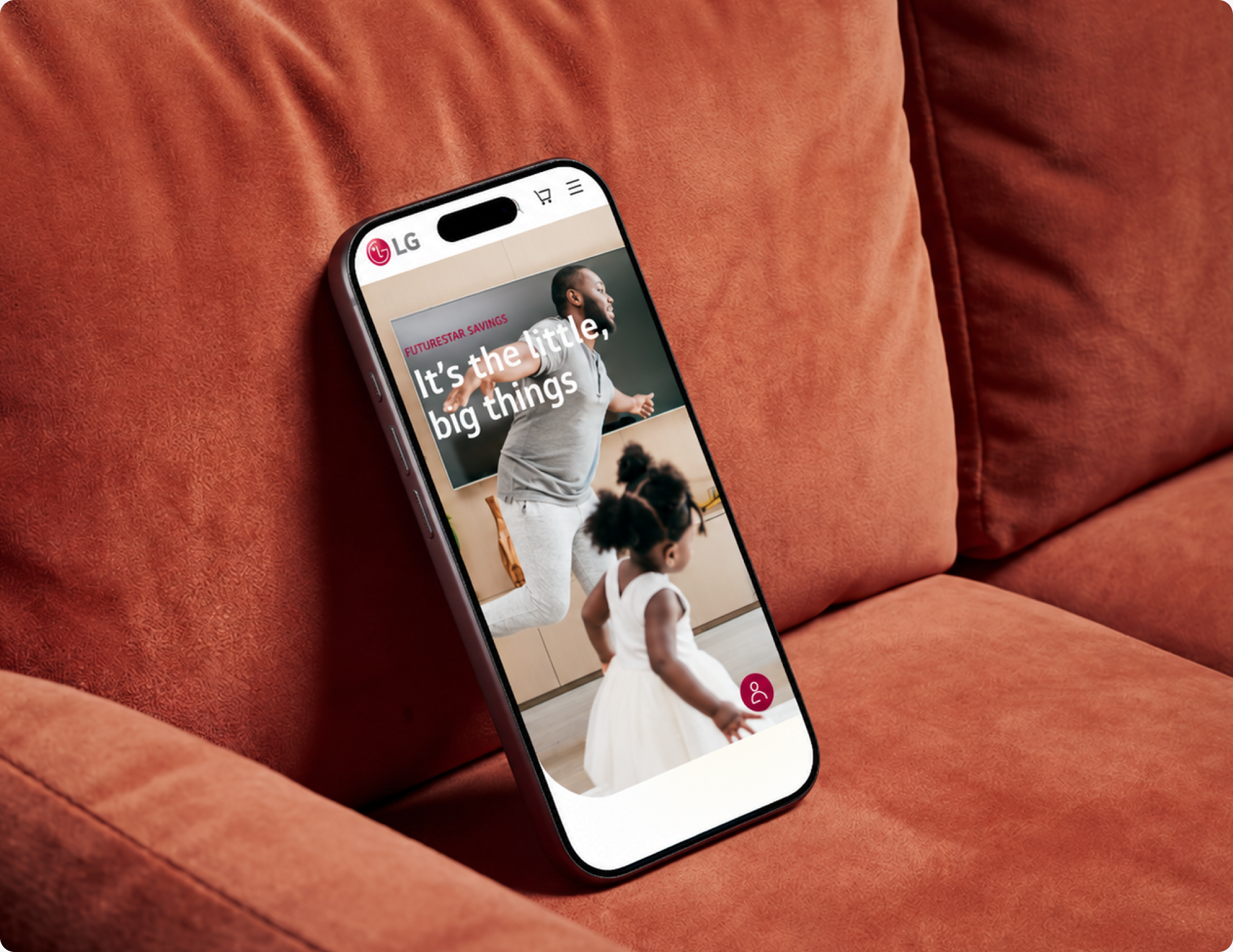 LG mobile shopping website on a phone resting against an orange sofa