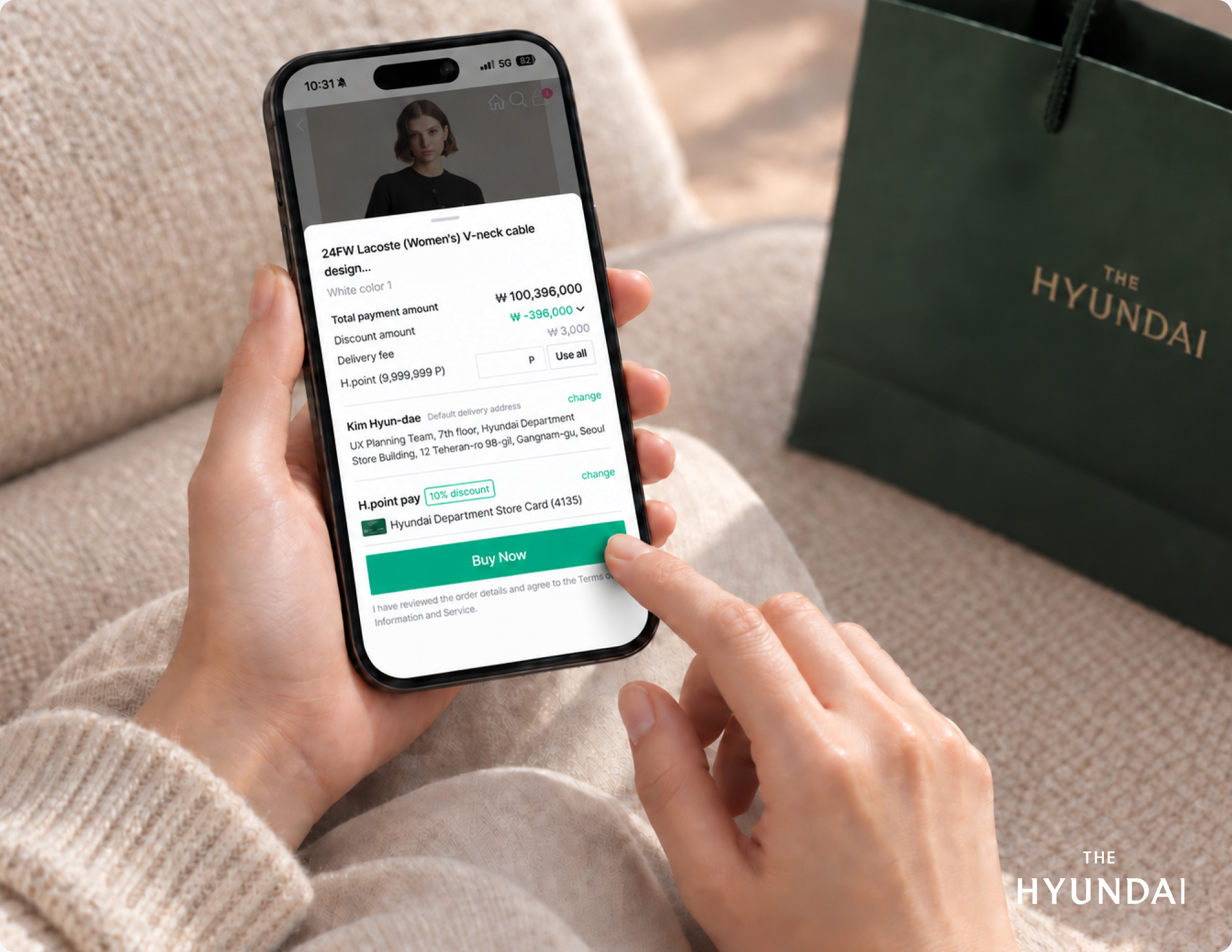 The Hyundai checkout on a phone held beside a shopping bag